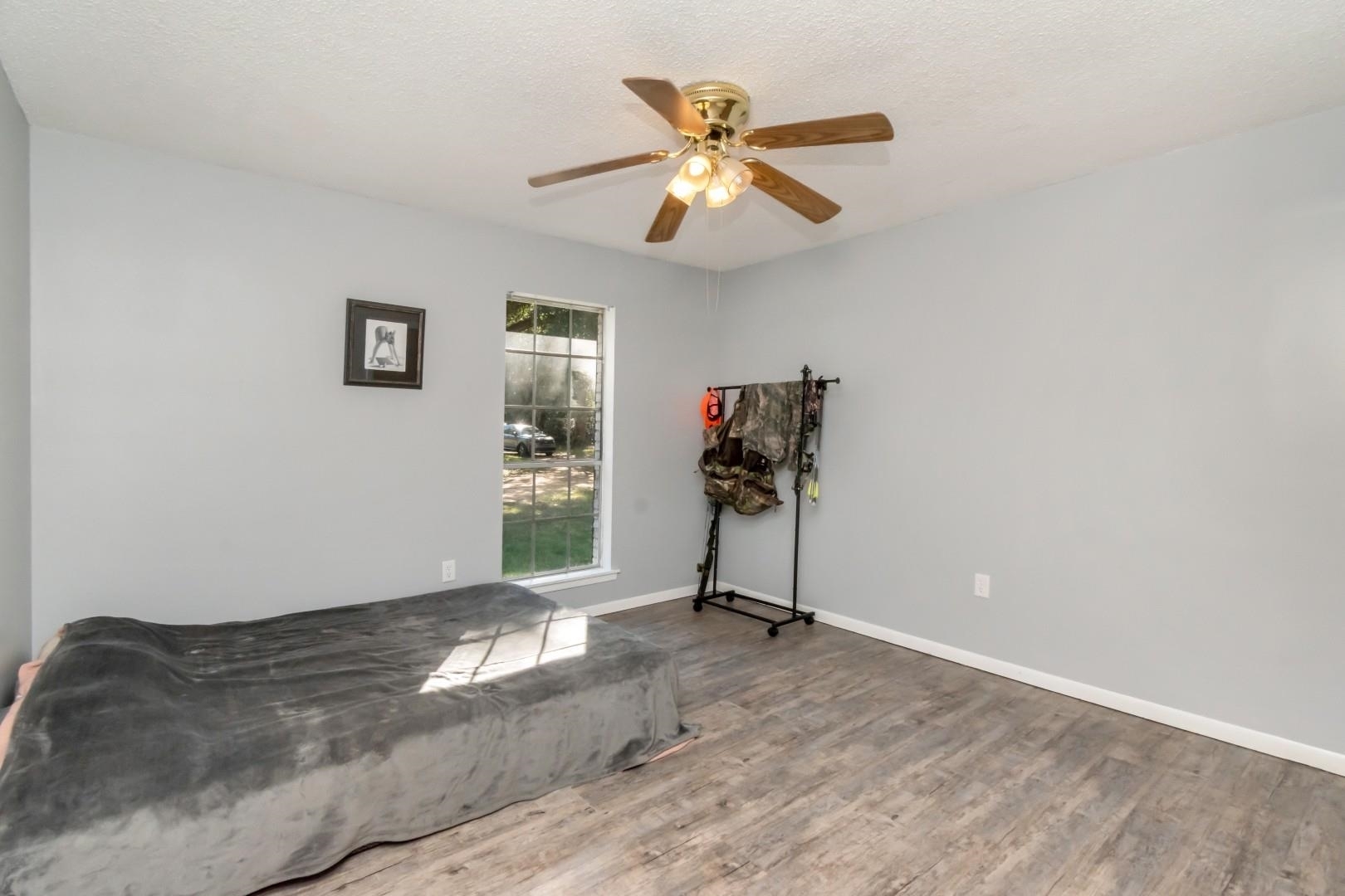 6405 1st Street Wilmer, AL 36587 - Photo 15 of 38 Bedroom featuring wood finished floors, ceiling fan, and a textured ceiling