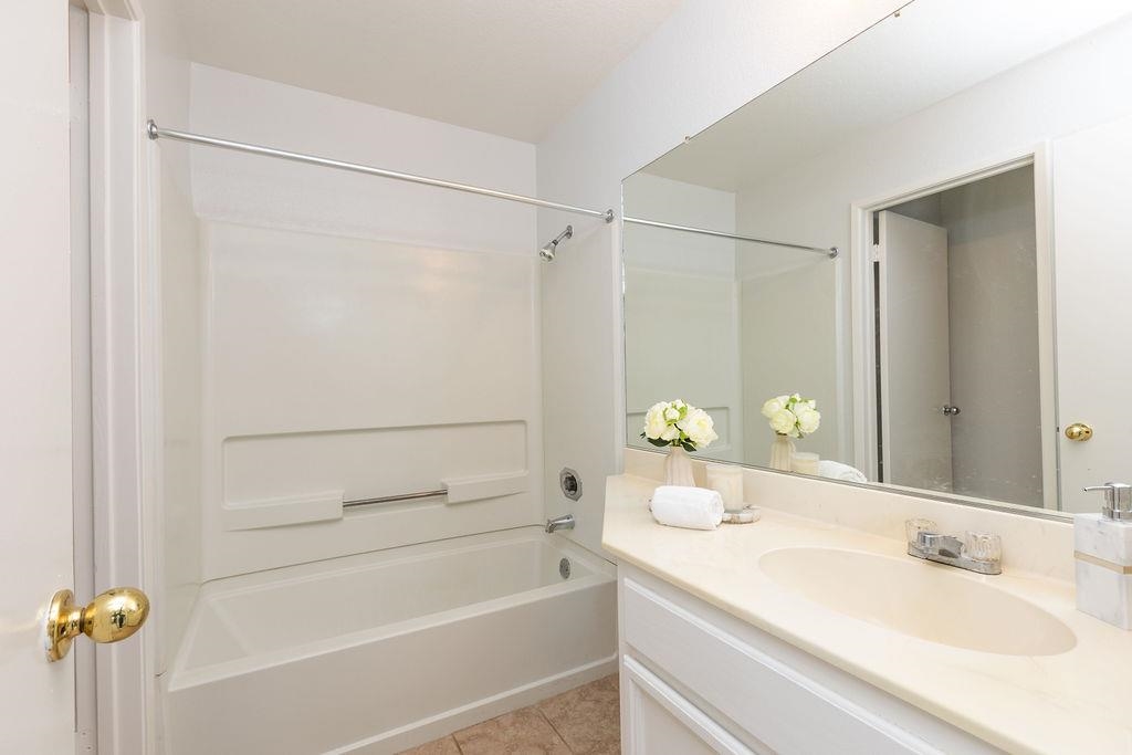 34565 Pueblo Terrace Fremont, CA 94555 - Photo 12 of 18 a bathroom with a tub shower vanity and a sink