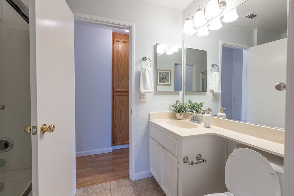 34565 Pueblo Terrace Fremont, CA 94555 - Photo 15 of 18 a bathroom with a sink a toilet a mirror and shower