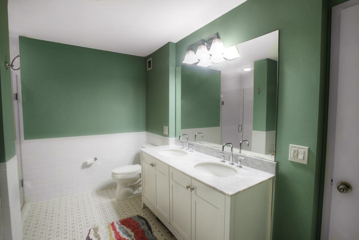 700 Grove Street, Unit 12J Jersey City, NJ 07310 - Photo 9 of 16 a bathroom with a sink and a mirror