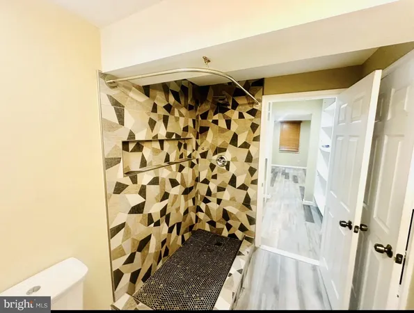 a bathroom with a shower and a mirror