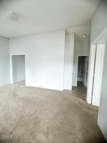 a view of an empty room and closet area