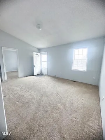 a view of an empty room with windows