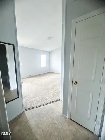 a view of livingroom with hardwood floor and front door