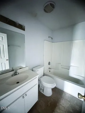 a bathroom with a double vanity sink mirror and toilet