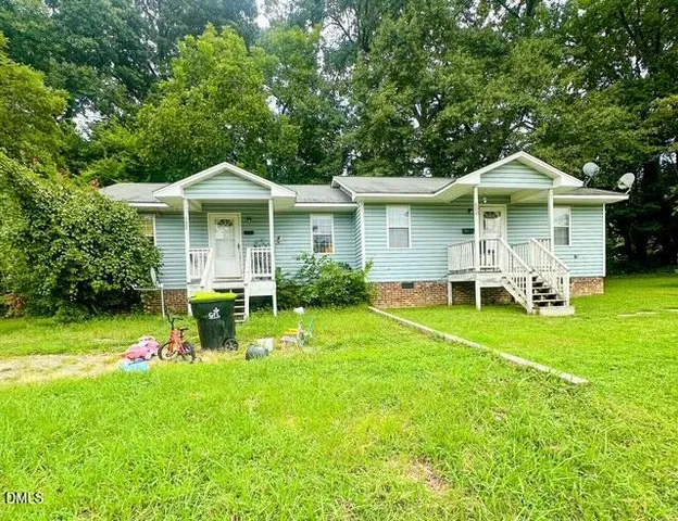 a view of a house with a yard porch and sitting area