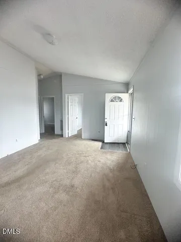 a view of an empty room with a windows