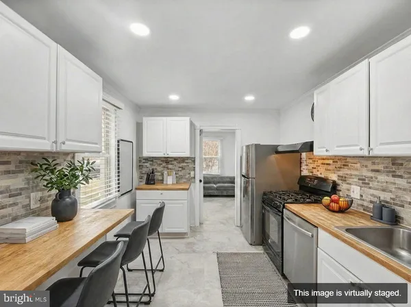 a kitchen with a table and chairs in it