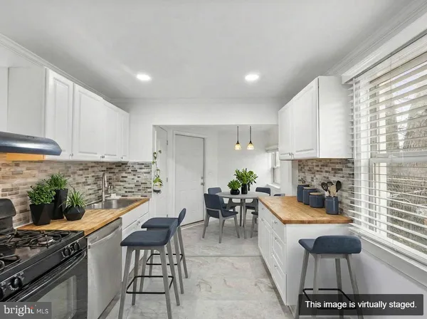 a kitchen with granite countertop lots of counter top space and stainless steel appliances