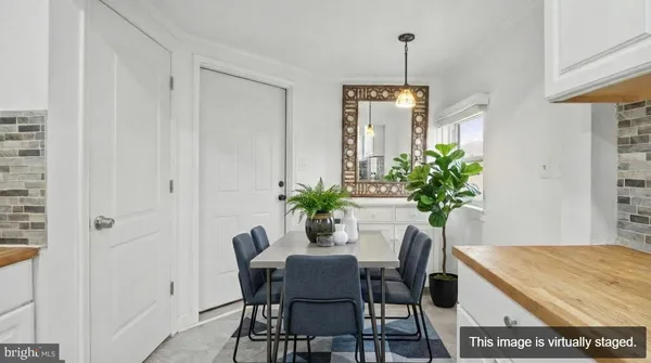 a dining room with furniture potted plants