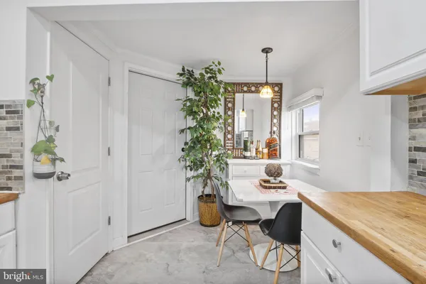 a dining room with a table and chairs