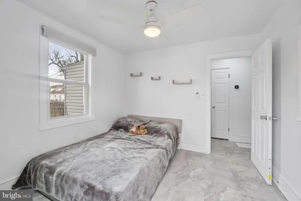 a bedroom with a bed and a window