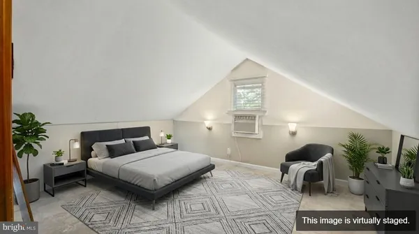 a bedroom with furniture and a potted plant