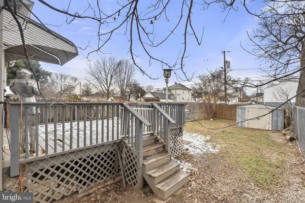 a view of a patio with a wooden fence