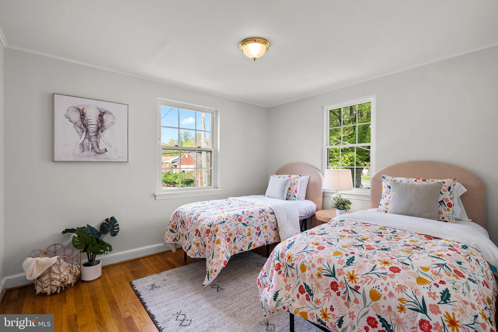 1012 Stirling Road Silver Spring, MD 20901 - Photo 25 of 44 a bedroom with two beds and a potted plant