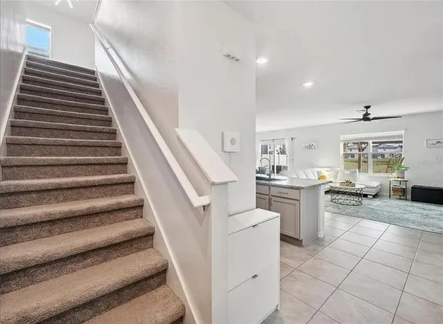 a view of a kitchen with furniture and staircase