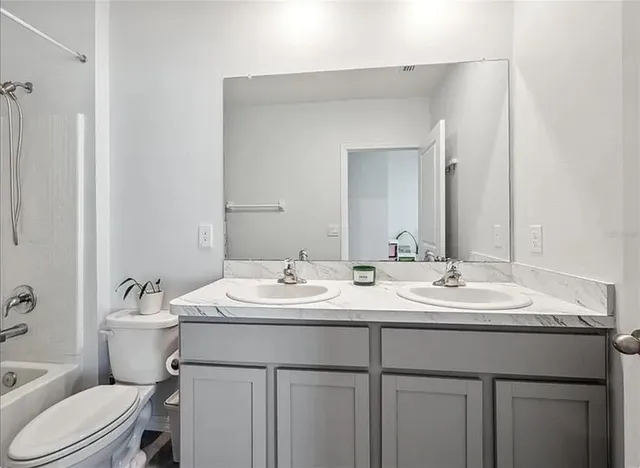 a living room with patio furniture and a large window