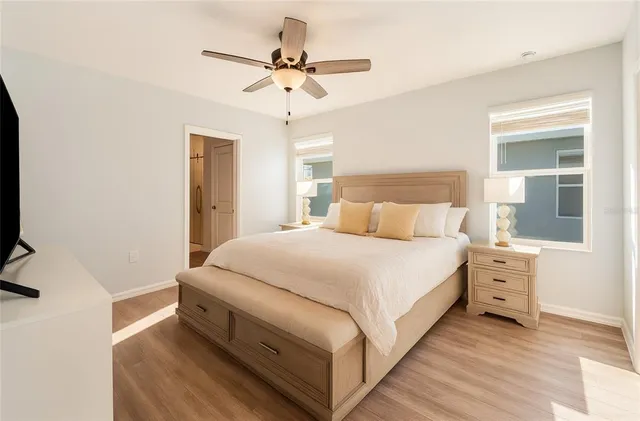 a bedroom with a bed and a chandelier