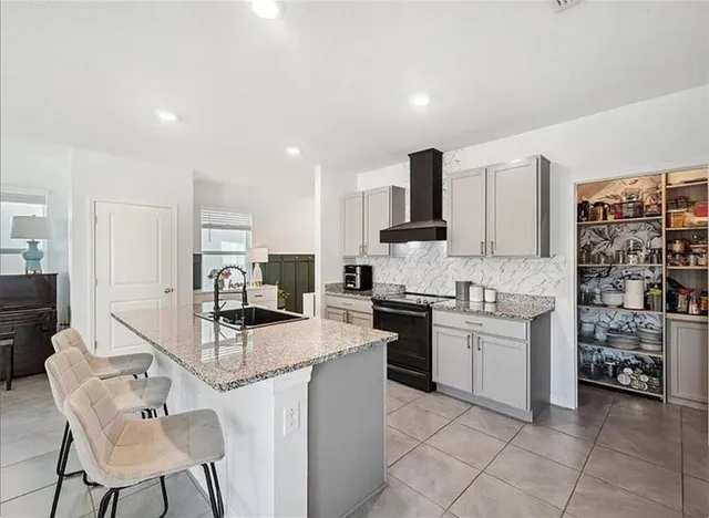 a kitchen with stainless steel appliances kitchen island granite countertop a sink and cabinets