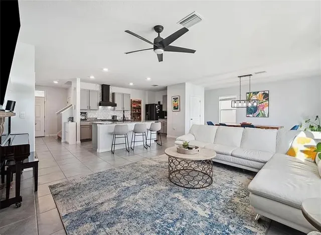 a living room with furniture and kitchen view