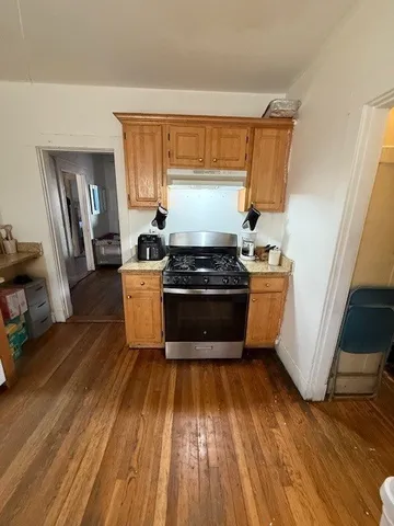 a kitchen with wooden floors and a sink