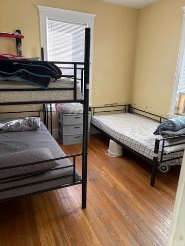 a bedroom with furniture and wooden floor