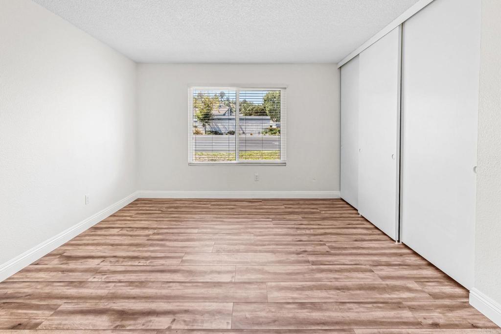 965 Jamacha Road El Cajon, CA 92019 - Photo 13 of 28 a view of an empty room with wooden floor and a window