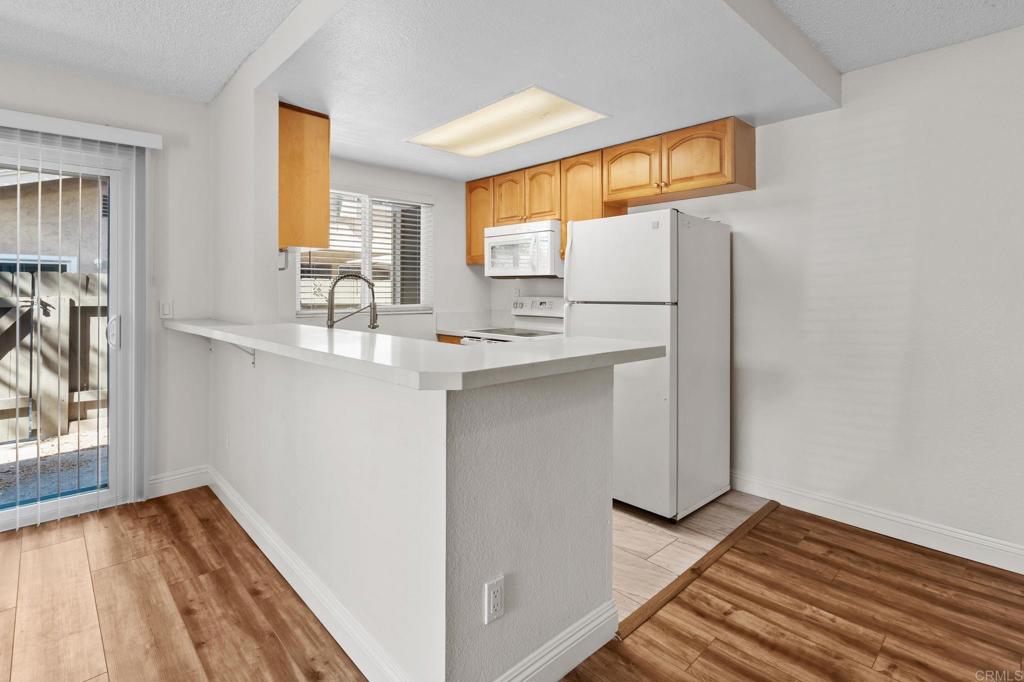 965 Jamacha Road El Cajon, CA 92019 - Photo 6 of 28 a view of kitchen with wooden floor and electronic appliances