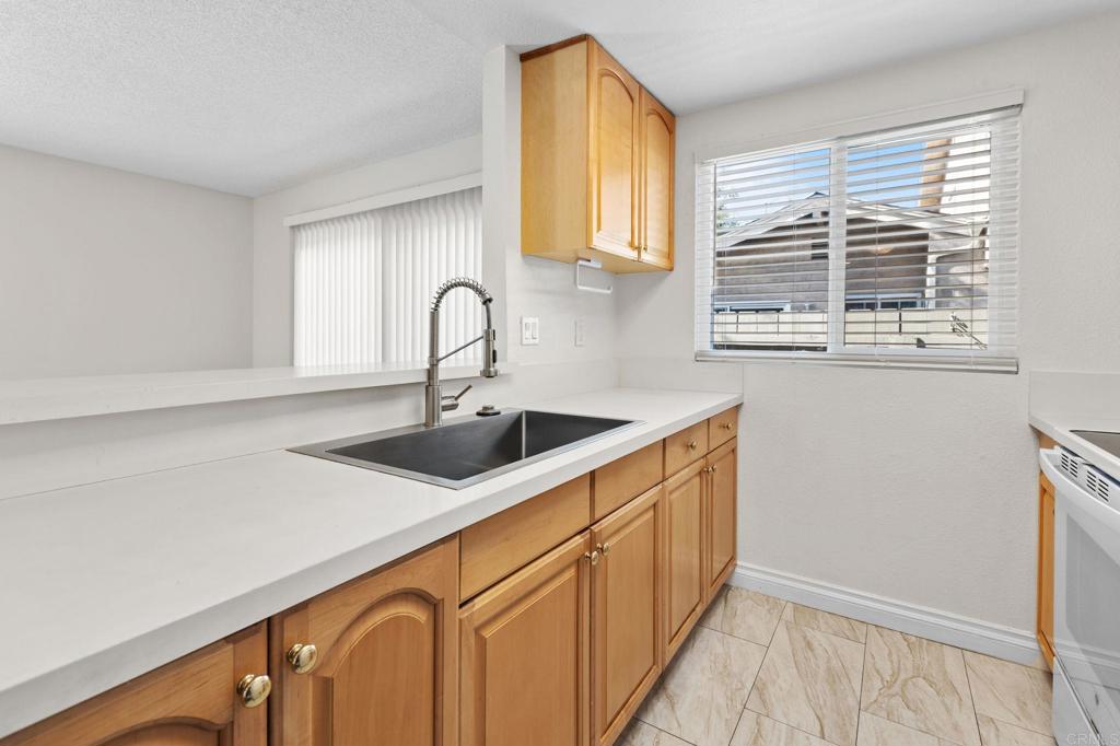 965 Jamacha Road El Cajon, CA 92019 - Photo 8 of 28 a kitchen with stainless steel appliances granite countertop a sink a window and cabinets