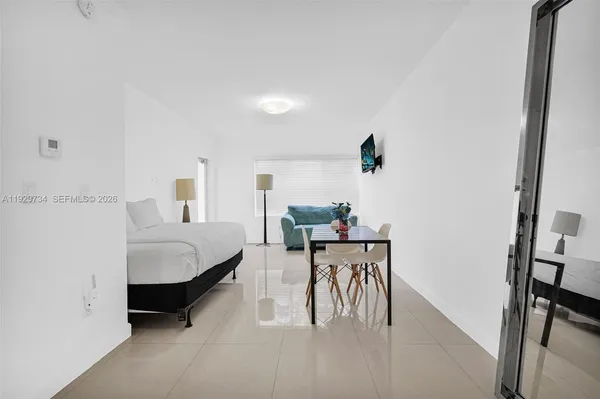 a bedroom with furniture and a rug