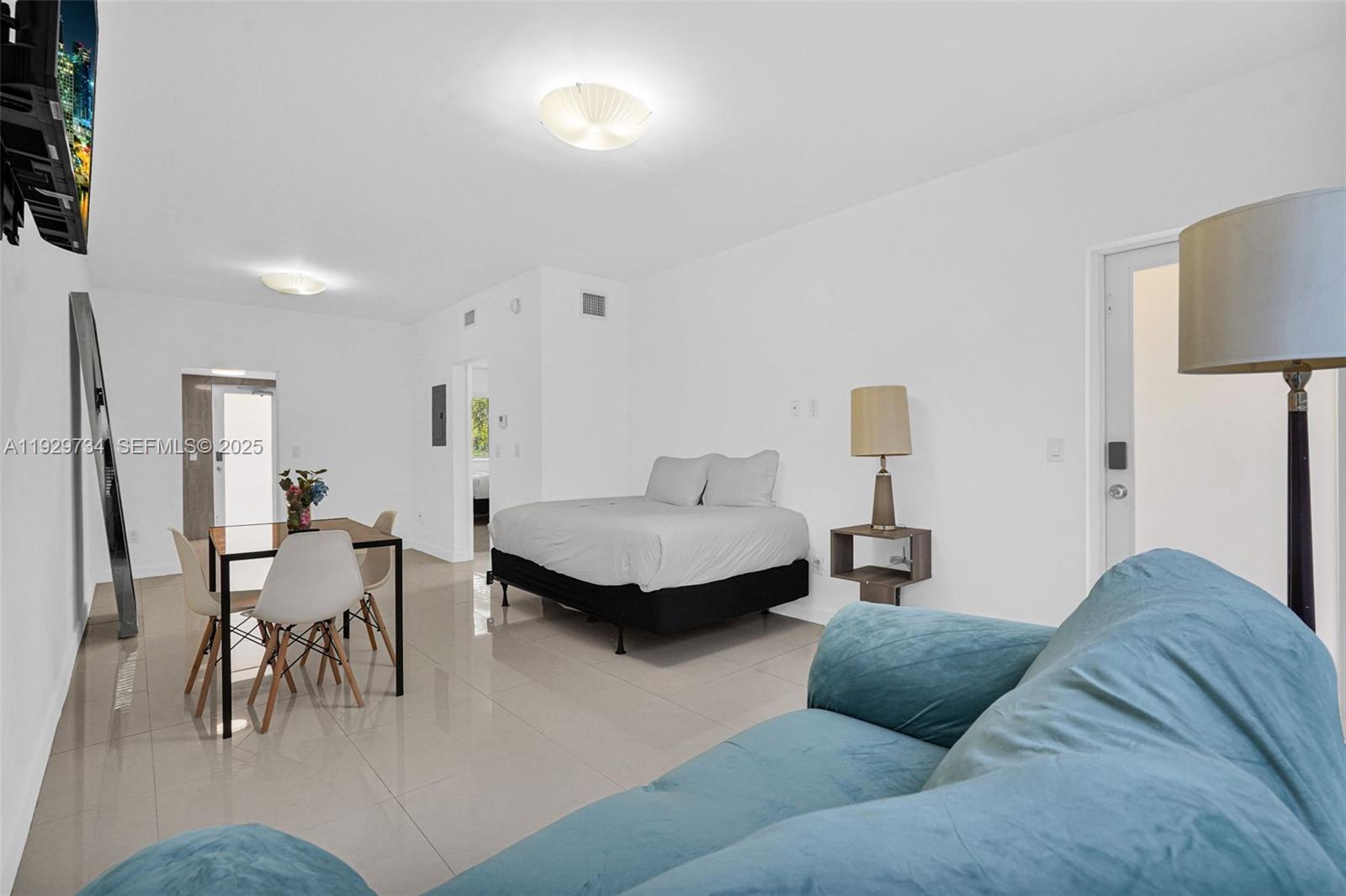 1025 94th Street, Unit 9 Bay Harbor Islands, FL 33154 - Photo 19 of 21 a living room with furniture and a table