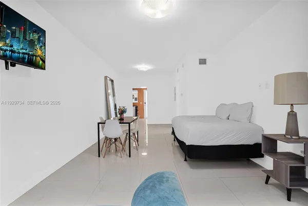 a living room with furniture and a lamp