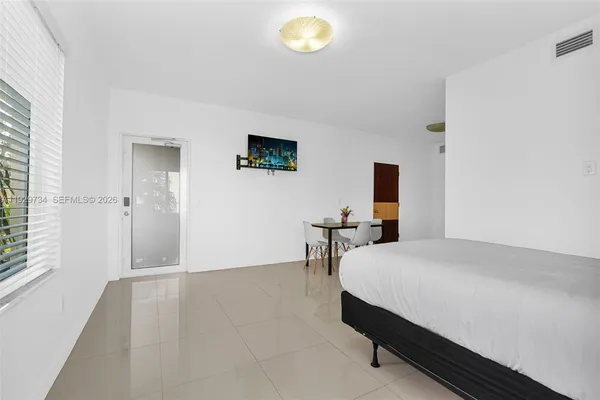 a bedroom with a bed and a table in it