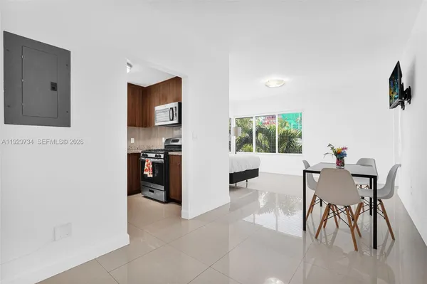 a view of a dining room with furniture and wooden floor