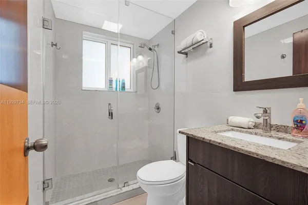 a bedroom with a large bed and a large window