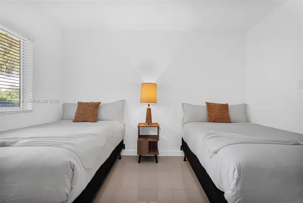 a bedroom with bed and window