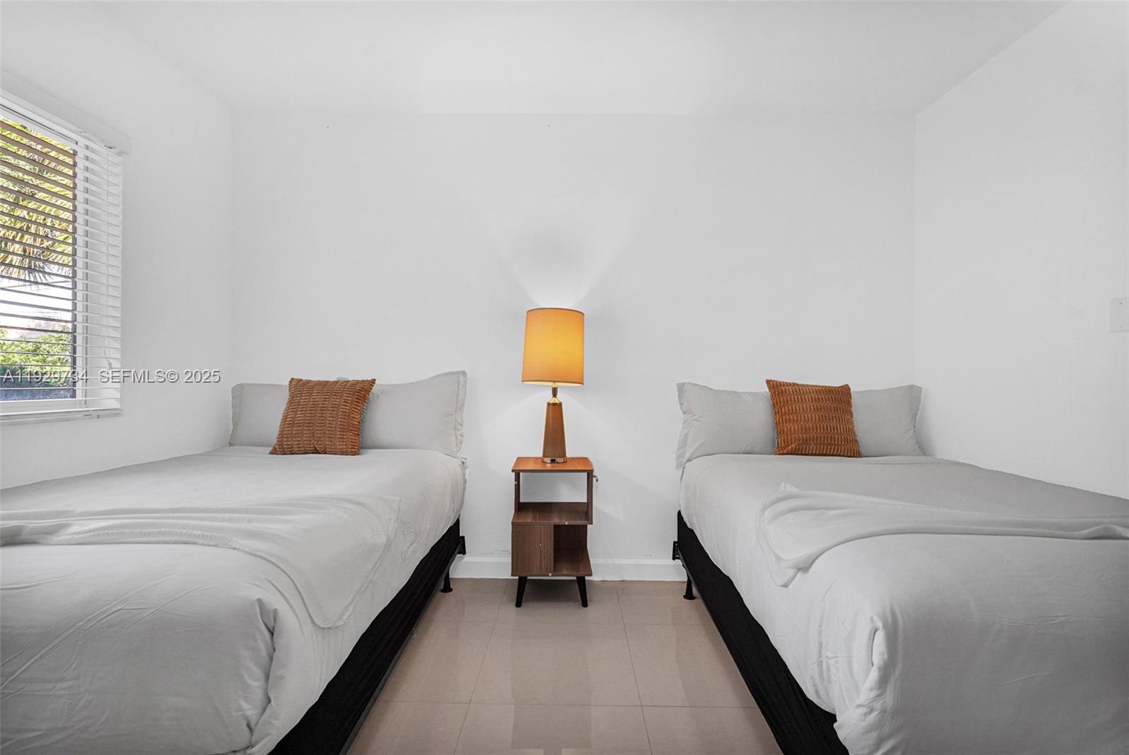 1025 94th Street, Unit 9 Bay Harbor Islands, FL 33154 - Photo 6 of 21 a bedroom with bed and window