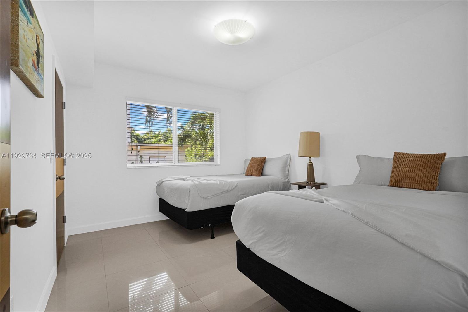 1025 94th Street, Unit 9 Bay Harbor Islands, FL 33154 - Photo 7 of 21 a bedroom with bed and window