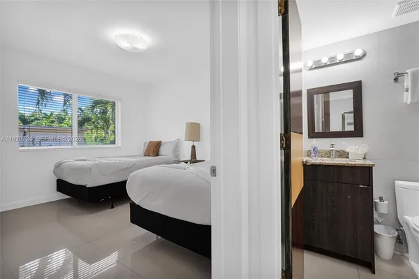 a bedroom with bed and window