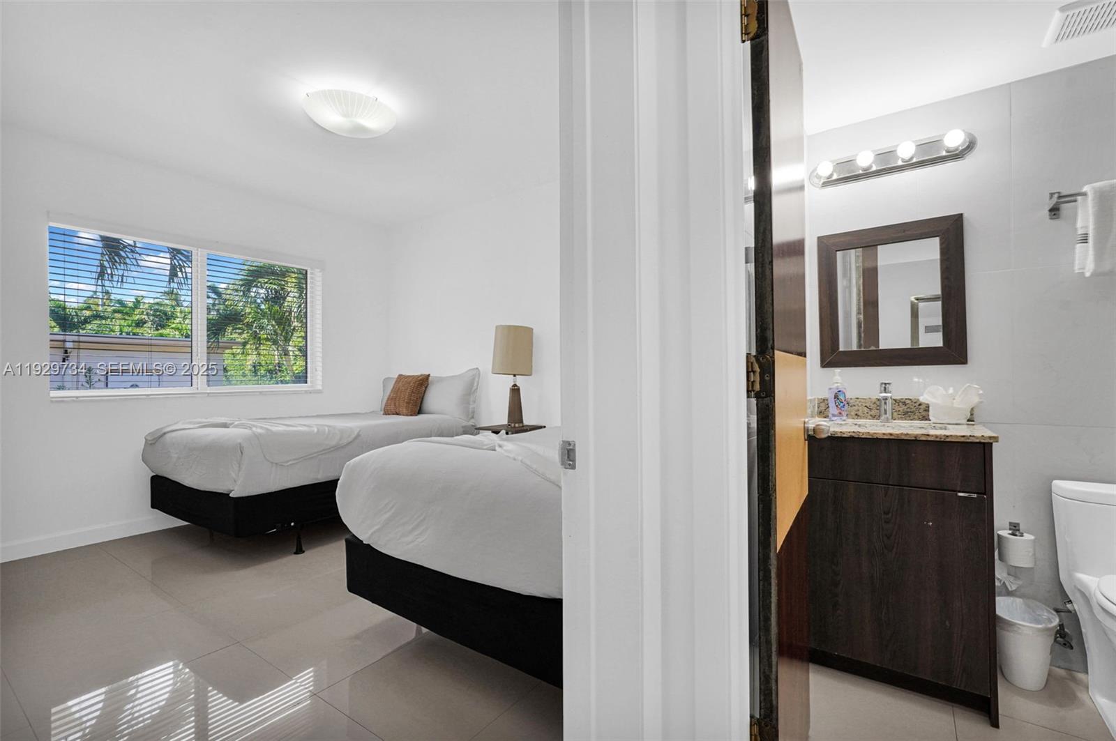 1025 94th Street, Unit 9 Bay Harbor Islands, FL 33154 - Photo 8 of 21 a bedroom with bed and window