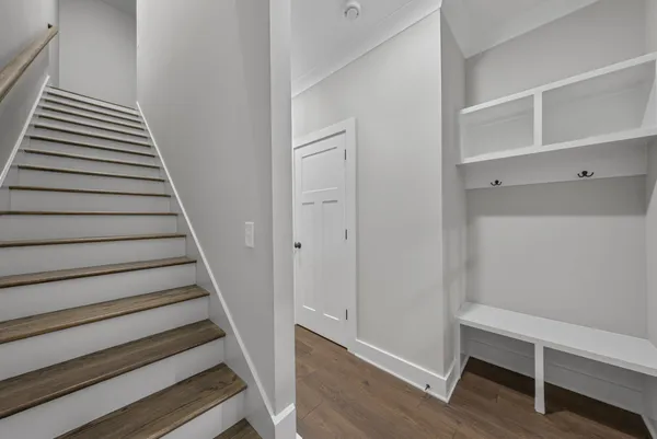 a view of a hallway with wooden floor and entryway