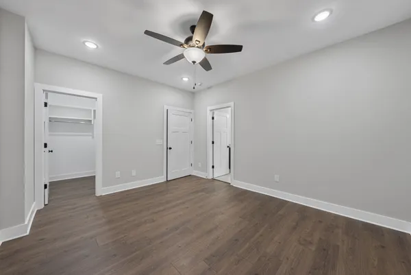 a view of an empty room with wooden floor