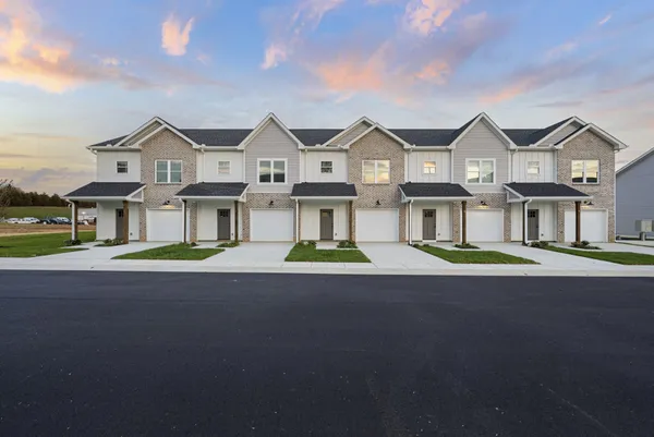 a view of multiple houses with a street