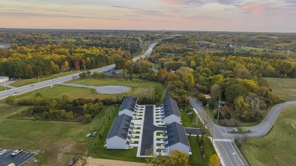 an aerial view of residential houses with outdoor space