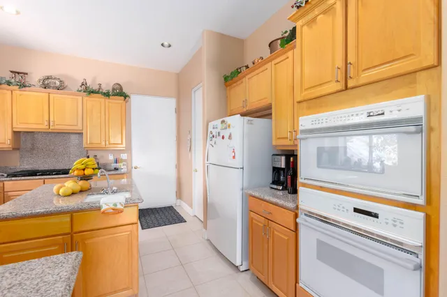 a kitchen with a refrigerator and a stove