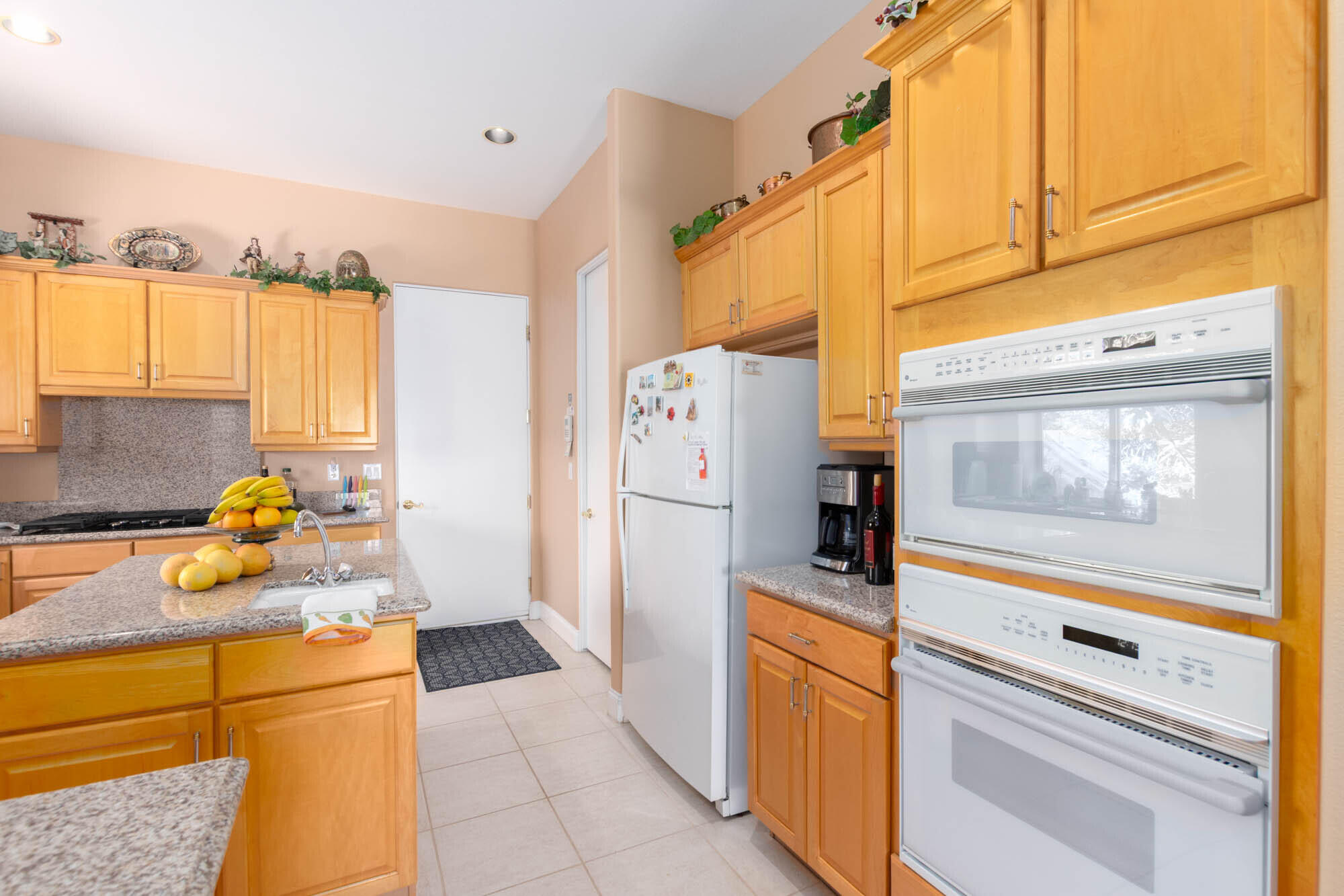 4 Bentley Road Rancho Mirage, CA 92270 - Photo 12 of 13 a kitchen with a refrigerator and a stove