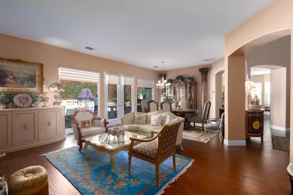 a living room with furniture and wooden floor