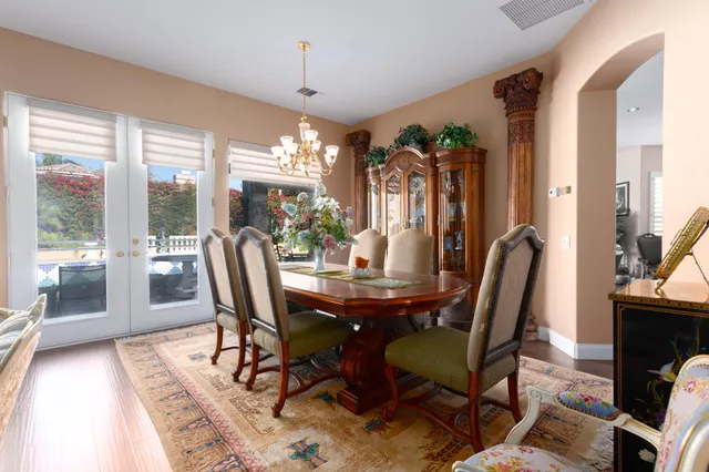 a view of a dining room with furniture wooden floor and chandelier