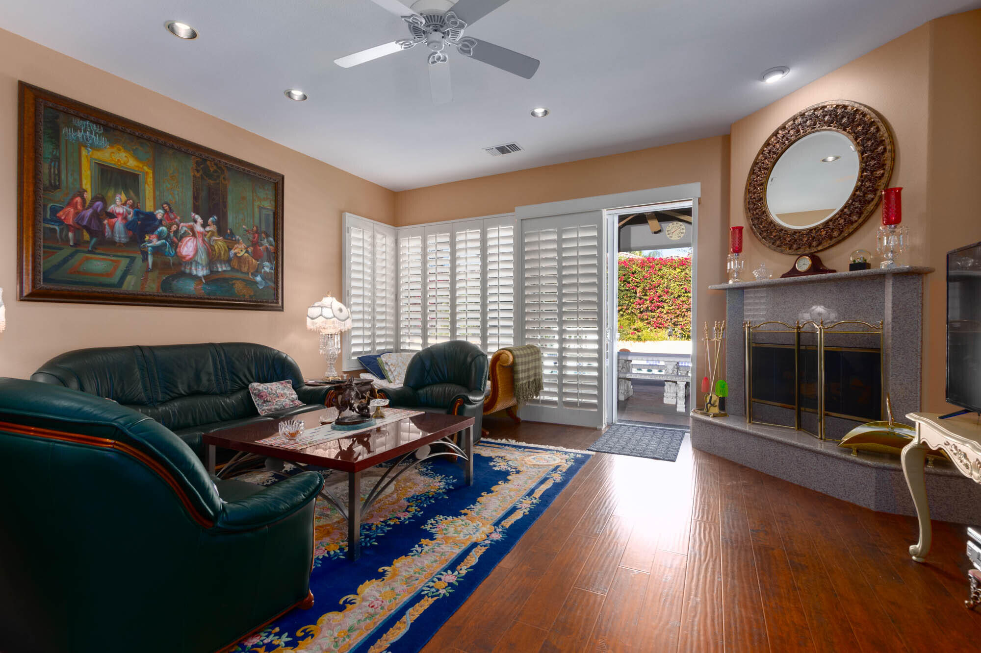 4 Bentley Road Rancho Mirage, CA 92270 - Photo 7 of 13 a living room with furniture a flat screen tv and a fireplace