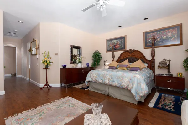 a bedroom with a bed and dresser with mirror